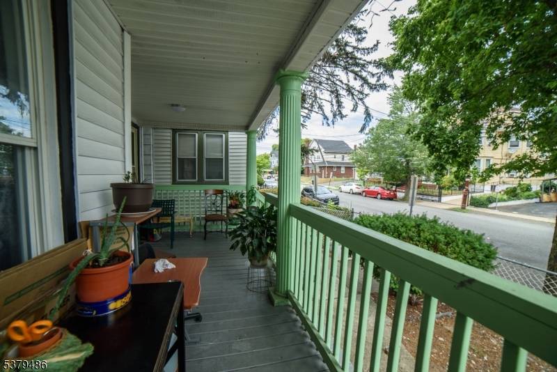 Welcome to this charming two family home nestled on a quiet, tree lined street !