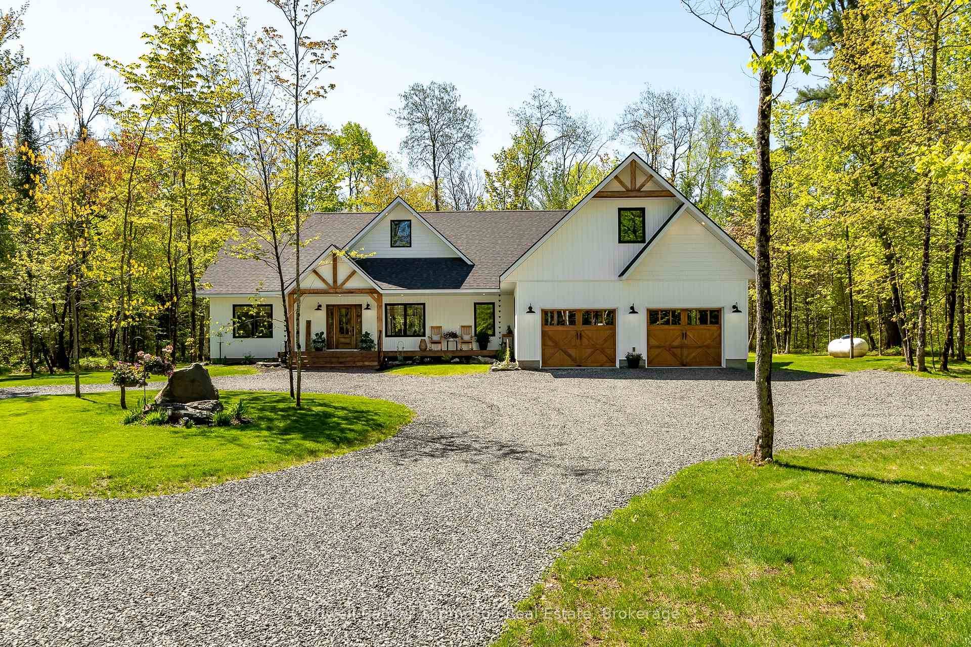 Welcome to this sprawling executive bungalow, built in 2022 and beautifully set on nearly 5 acres of lush, level land.
