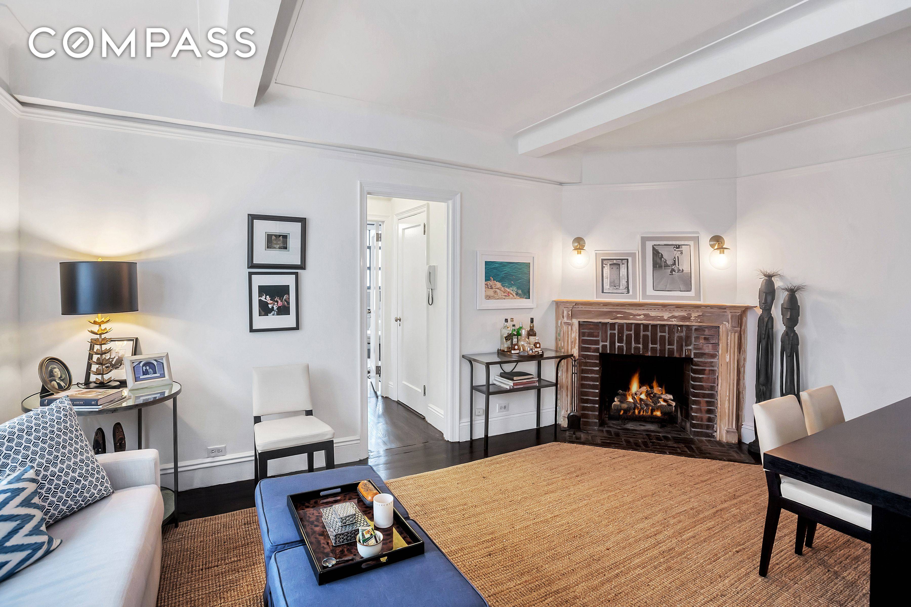 9P is a charming one bedroom apartment with a wood burning fireplace and northern views showcasing some of the city's most iconic buildings, including the Chrysler Building.