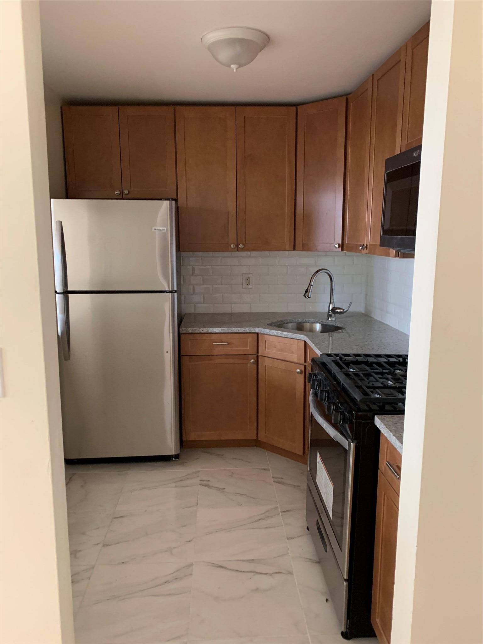 Welcome to this beautifully maintained legal 2 family property located on a charming historic landmark block.