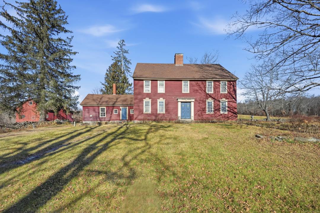 Step back in time with this enchanting New England Colonial set on a picturesque 3.