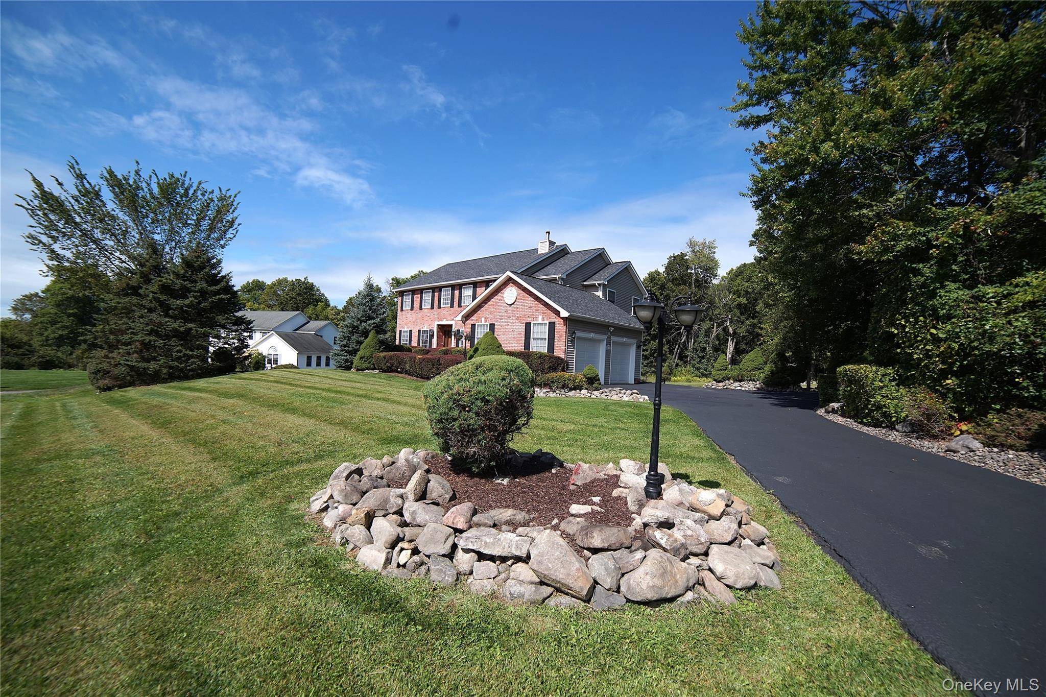 Experience refined suburban living at 21 Pinecrest Rd in Salisbury Mills, a stunning 2, 900 sq ft brick front colonial set on a picturesque 1.
