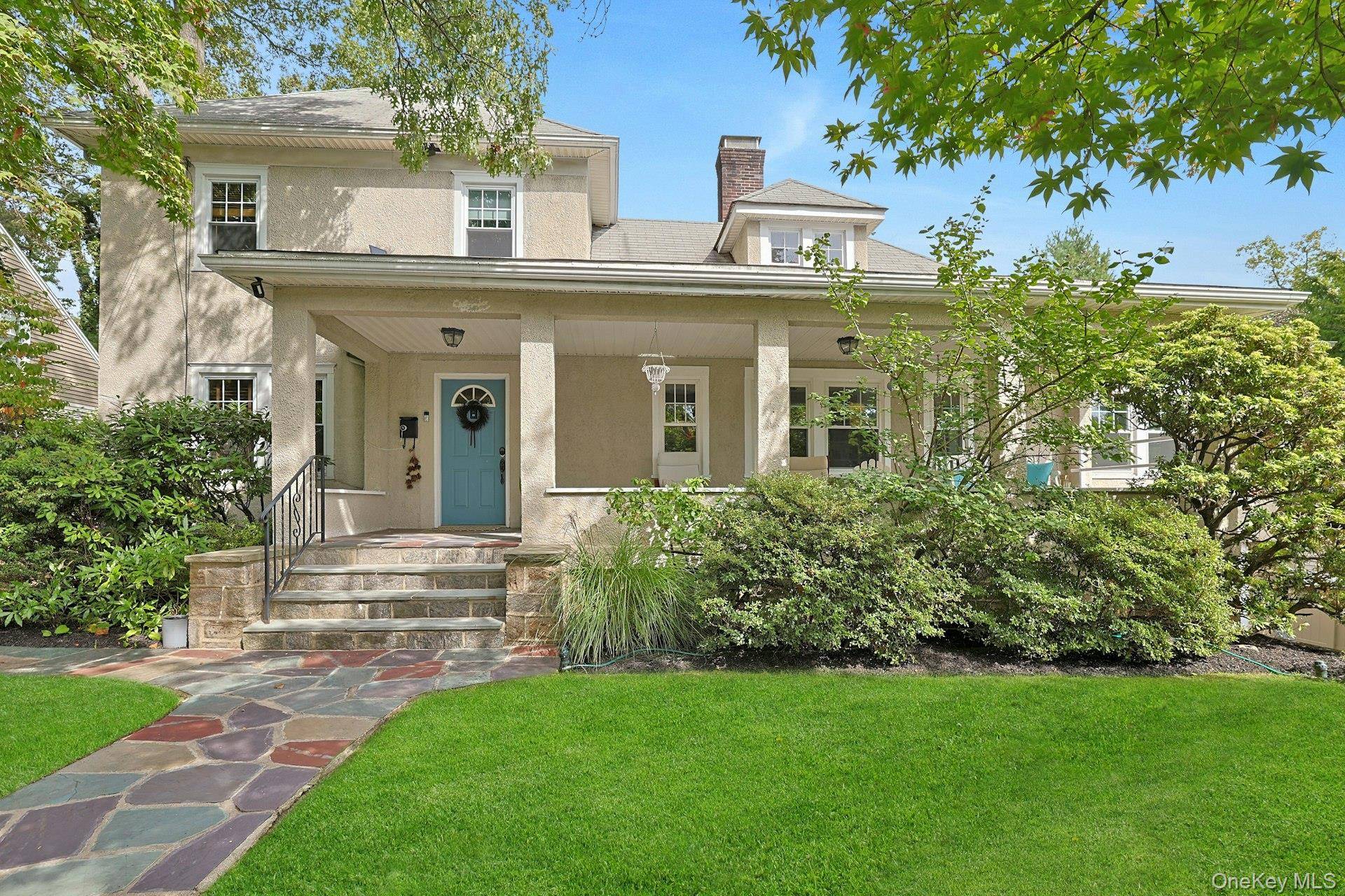This Stucco Colonial with delightful front porch exudes warmth and character.