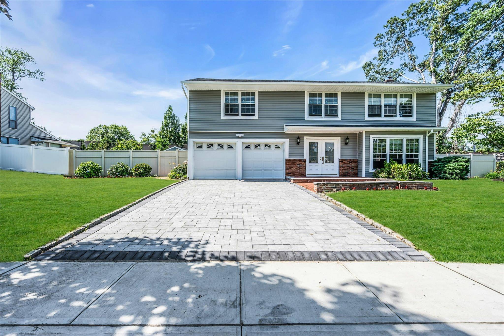 Large 5 Bedroom Brookfield Colonial with 2 Car Garage, Desirable Hauppauge Schools, Side Walks, New Eat In Kitchen with Quartz Counters, New Appliances, Finished Basement with OSE, Large Shed, Wood ...