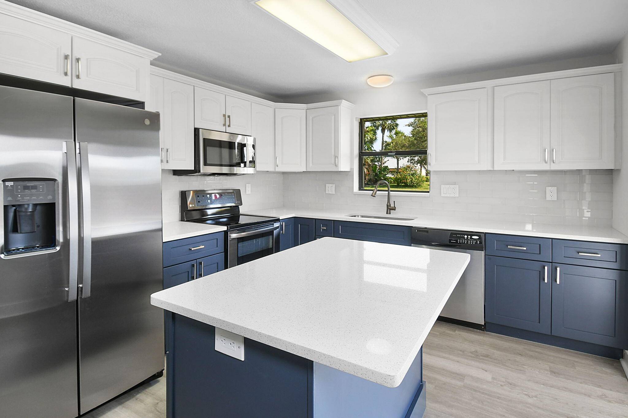 New A C, refrigerator, microwave, quartz countertops, backsplash, flooring downstairs, barn doors in owner's suite and so much more !