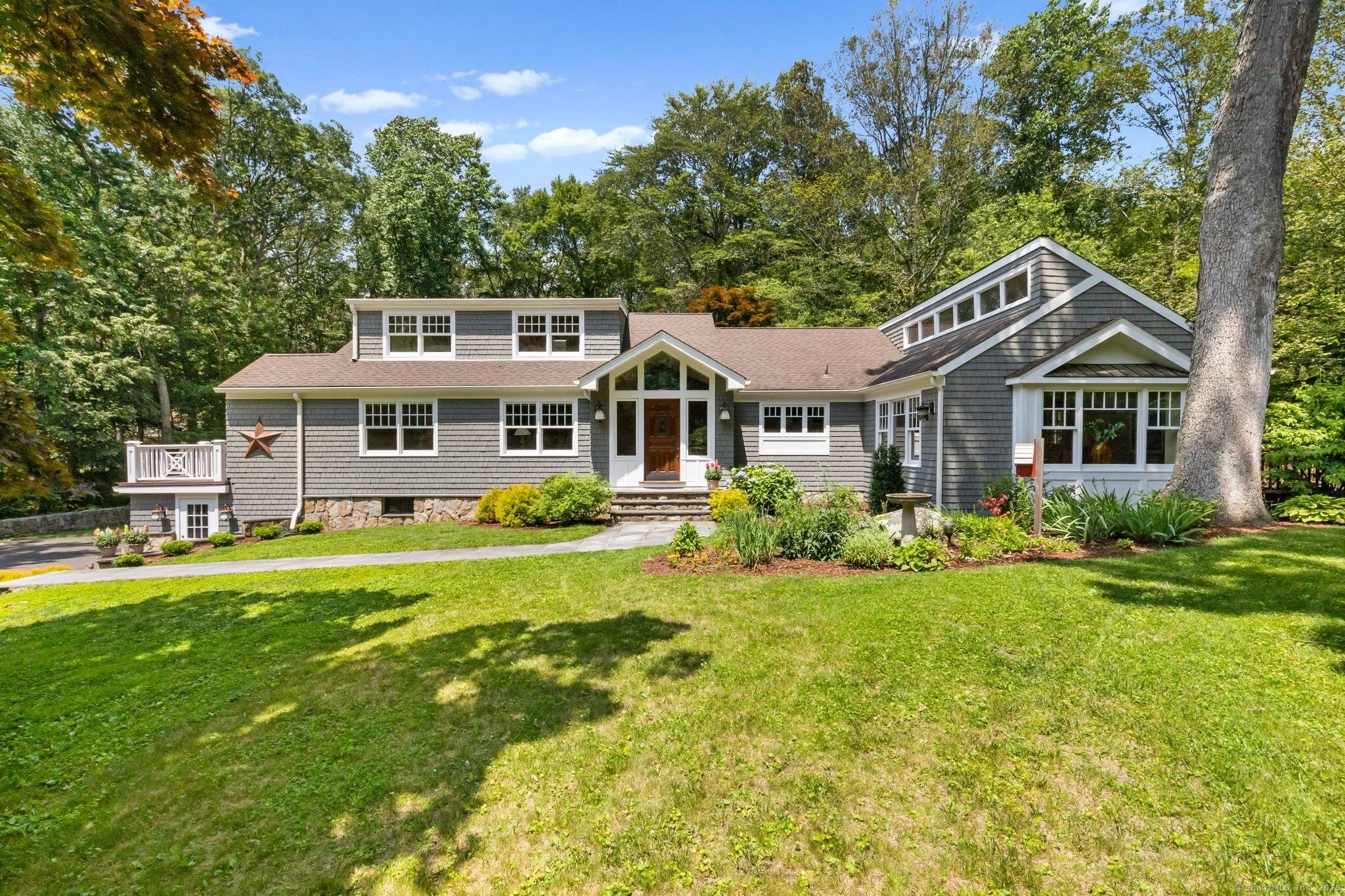 This updated Cape with its freshly painted exterior is set on a quiet culdesac with a park like and beautifully landscaped two acre parcel.