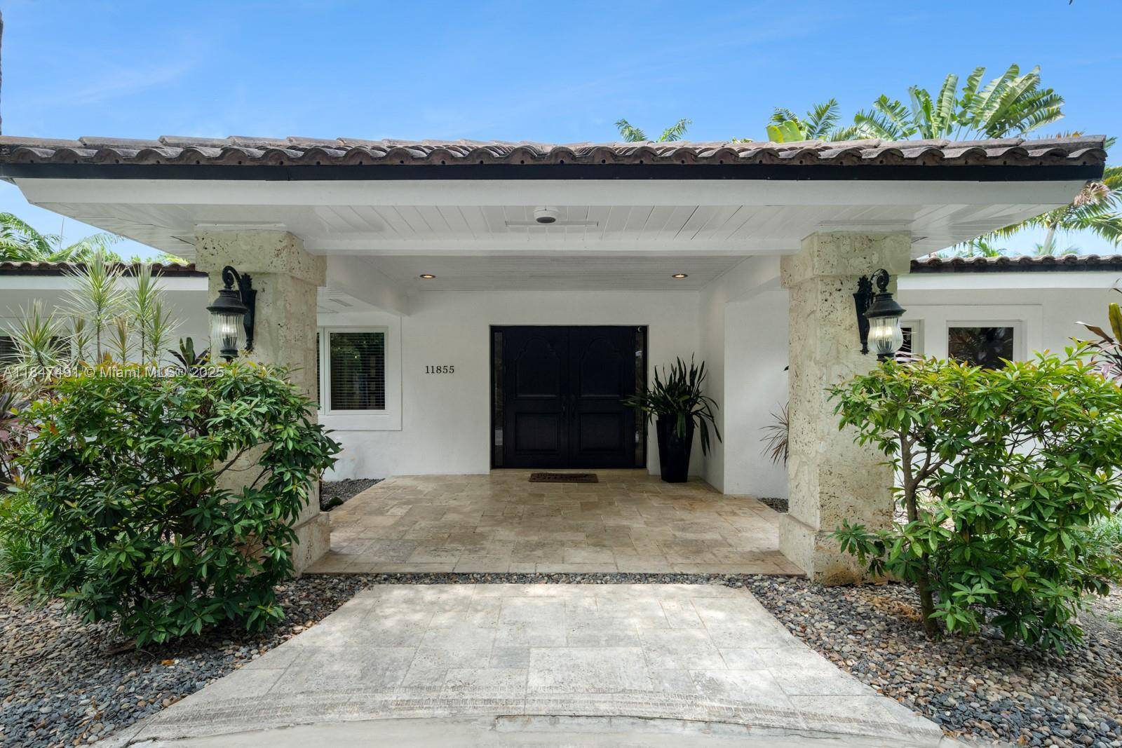 Experience elevated living in this gated one acre Pinecrest estate.