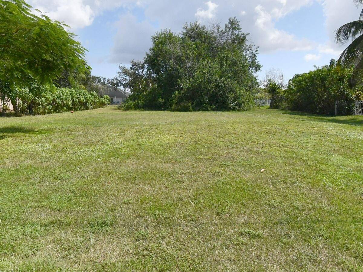 Partially cleared waterfront property on a wide canal.
