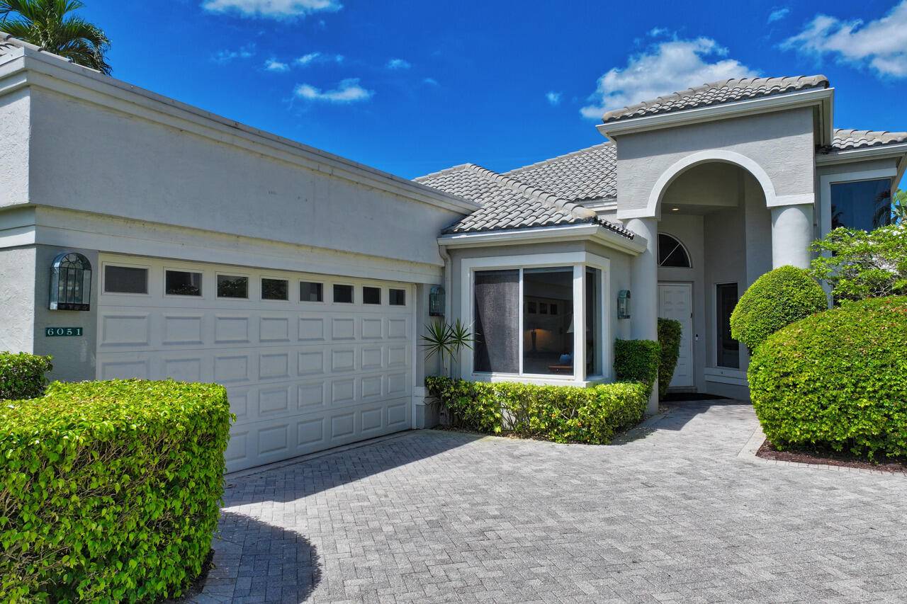 Welcome to this exquisite one story home located in the prestigious village of Fairway Lake within the award winning Broken Sound Country Club.