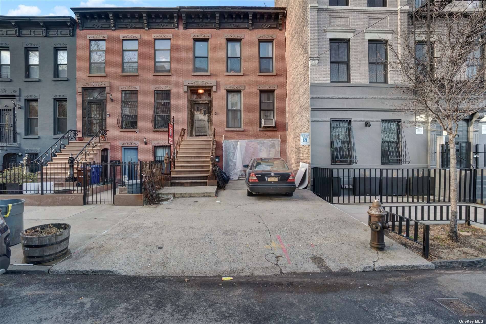 Here's that stunning big beautiful brown three story, two family townhouse with that quintessential turn of the century charm.