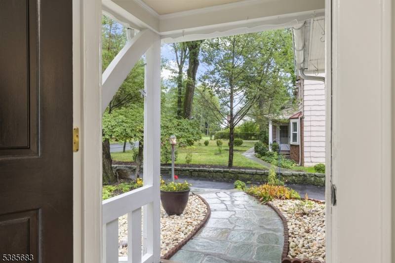 Stunning updated residence set on a rare 1 2 acre, park like lot in Millburn, offering a blend of timeless charm and modern sophistication.
