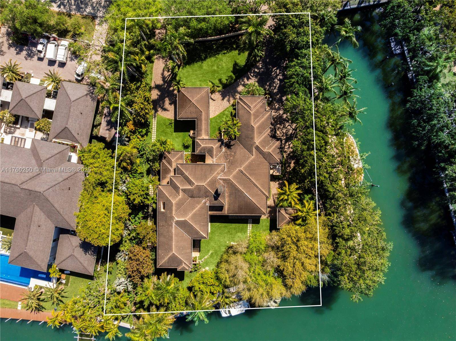 Designed by Barry Sugerman, this 7, 698 SF waterfront estate in Gables Estates is a true masterpiece of elegance and modern luxury.