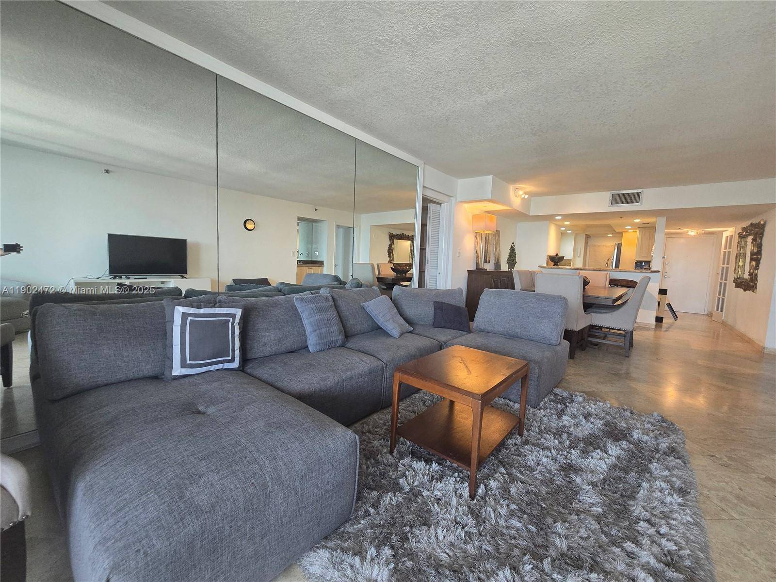 PENTHOUSE unit with a large balcony overlooking panoramic views of Biscayne Bay, Port of Miami, and the Miami skyline.