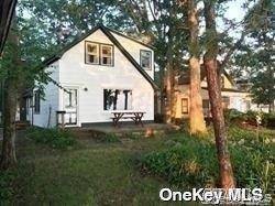 Live as if on vacation. This charming waterfront home offers spectacular views of Port Jefferson Harbor.