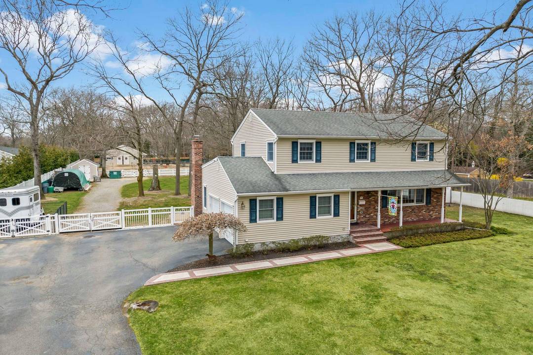 Traditional oversized impressive Colonial with a property to match.