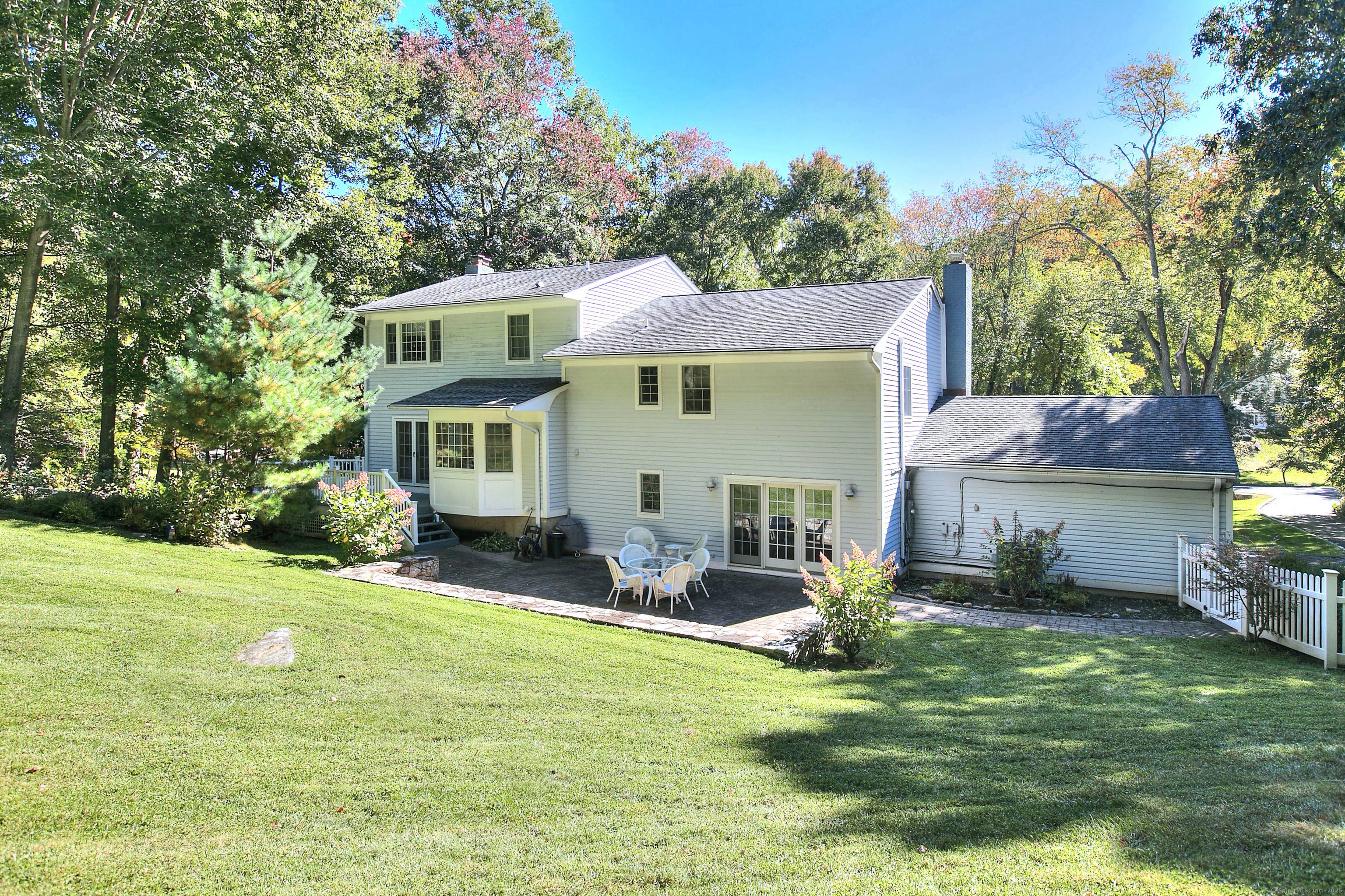 Located on a quiet neighborhood street, this 5 bedroom home spans a full acre, offering a tranquil setting for your summer retreat.