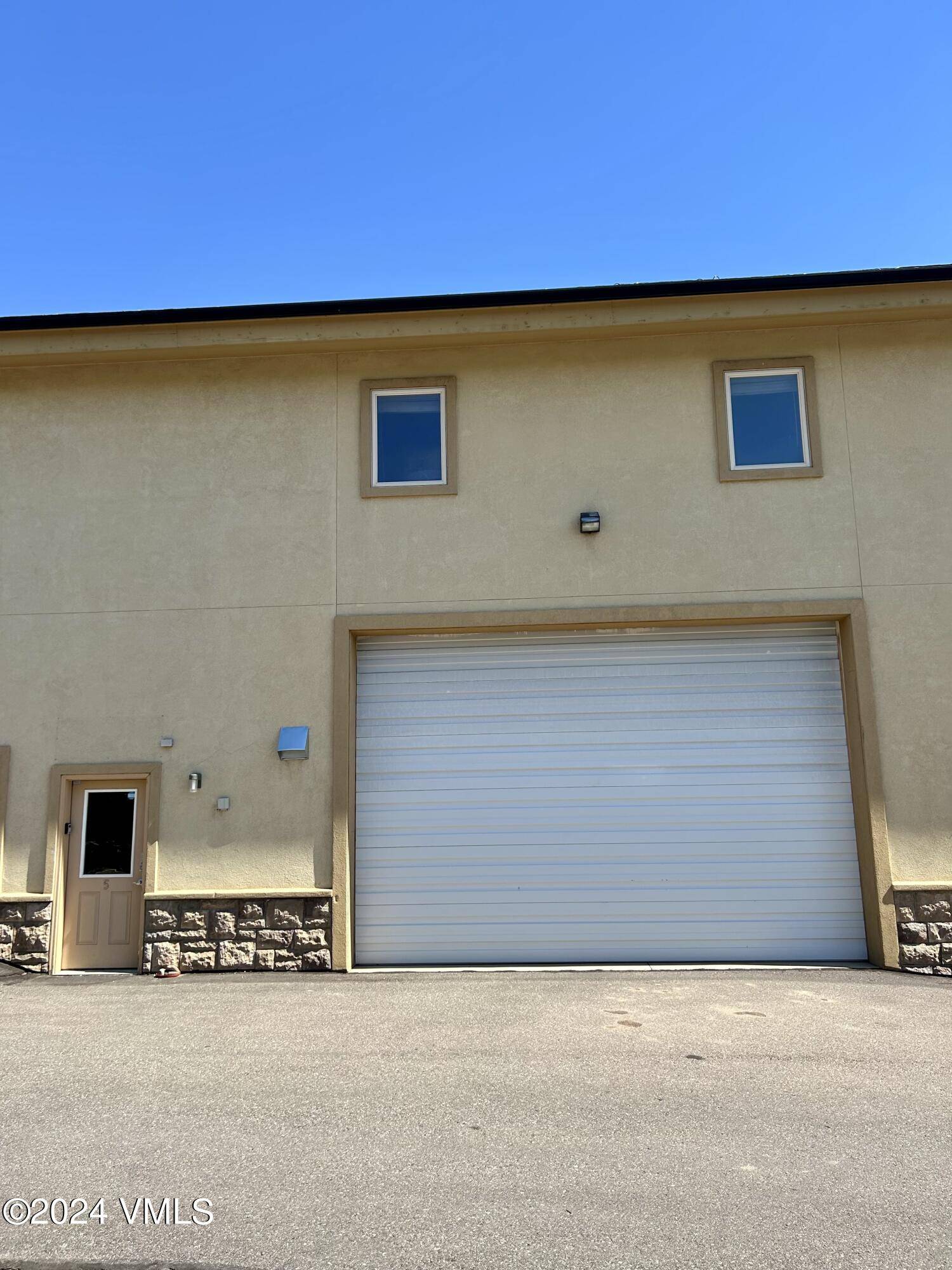 Light industrial zoned condominium warehouse unit in an attractive stucco building at the Eagle County Vail Airport.