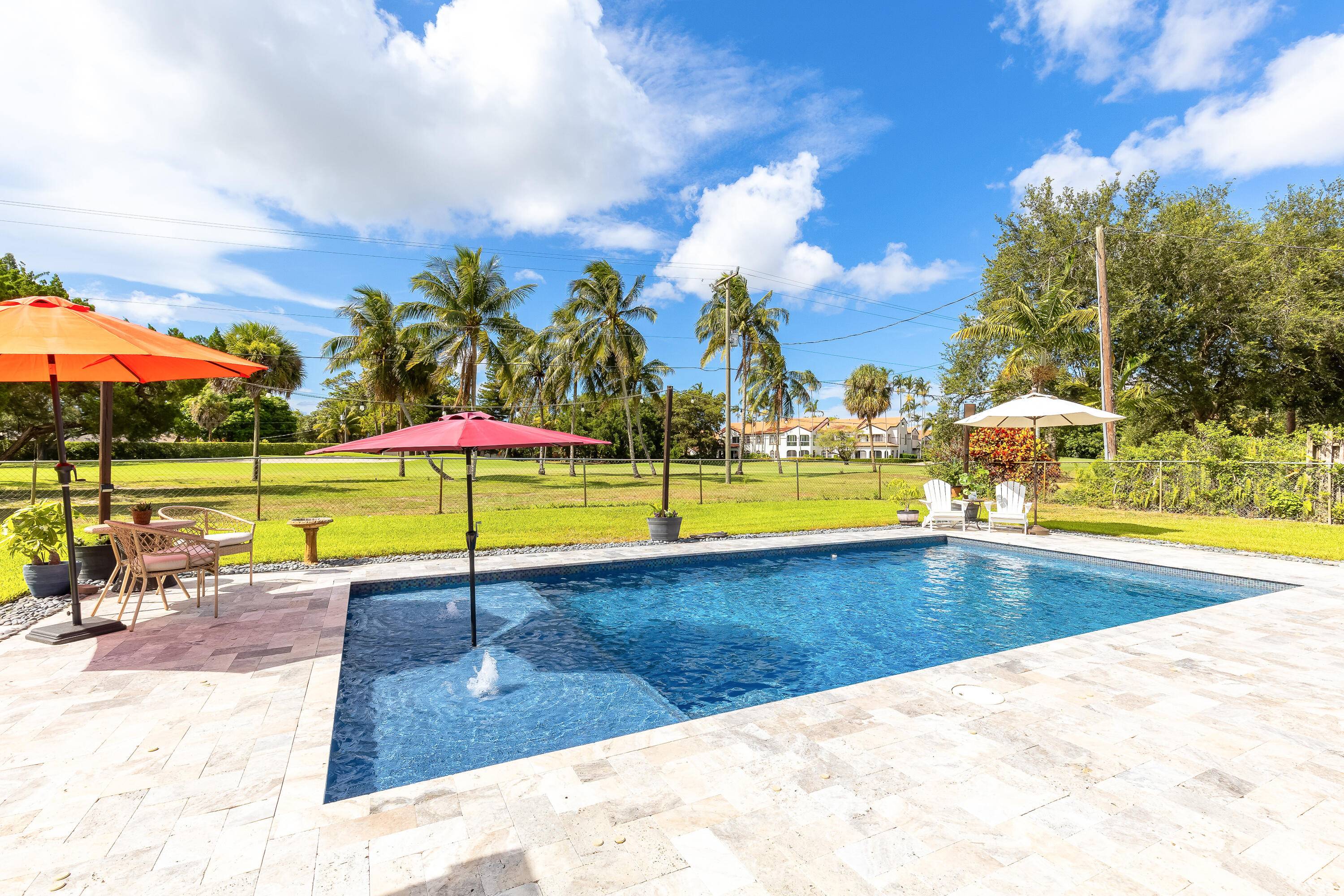 Your home search ends here in the highly desirable Palm Beach National Golf and Country Club, a unique, no HOA community with a public golf course open to all.