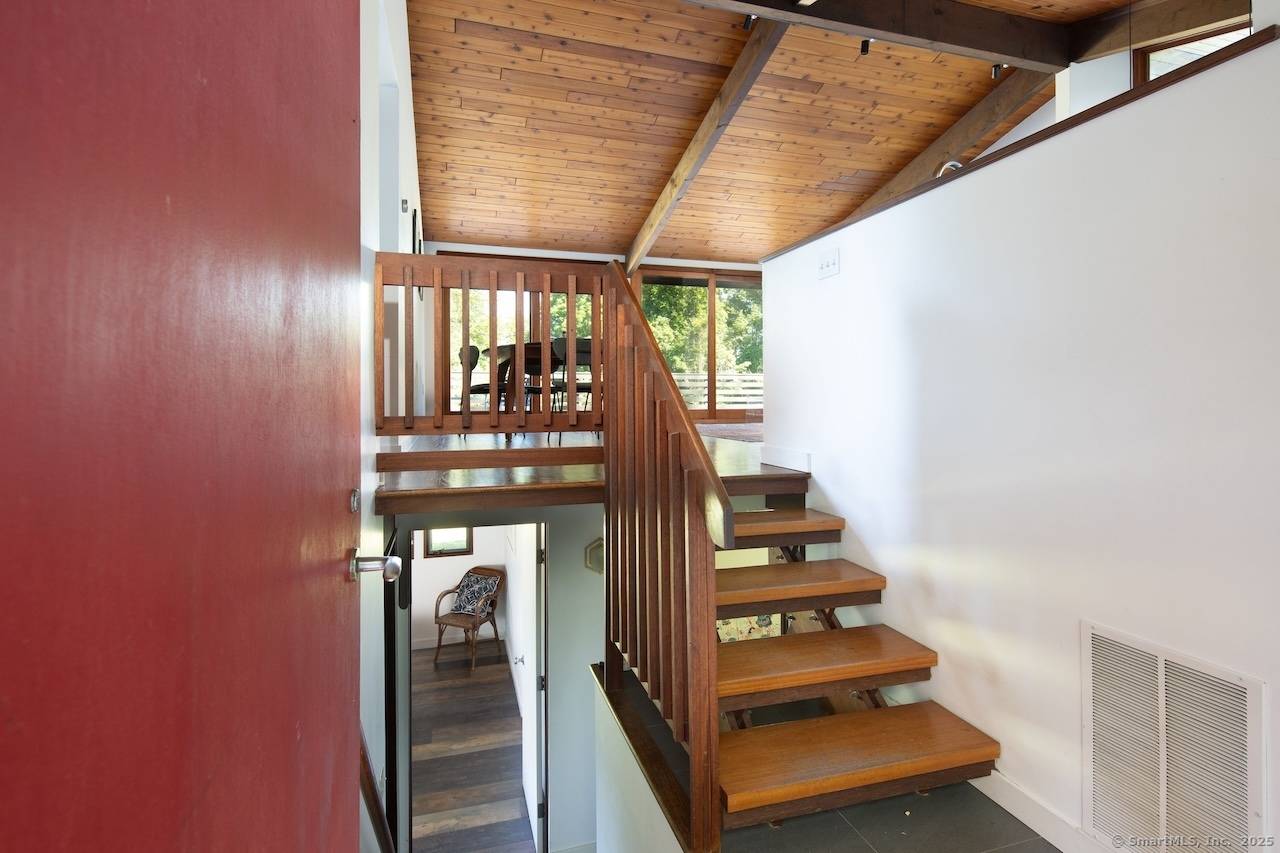 This distinctive mid century modern Deck House commands seasonal mountain views across the rolling landscape of Northwest Connecticut's Litchfield Hills.