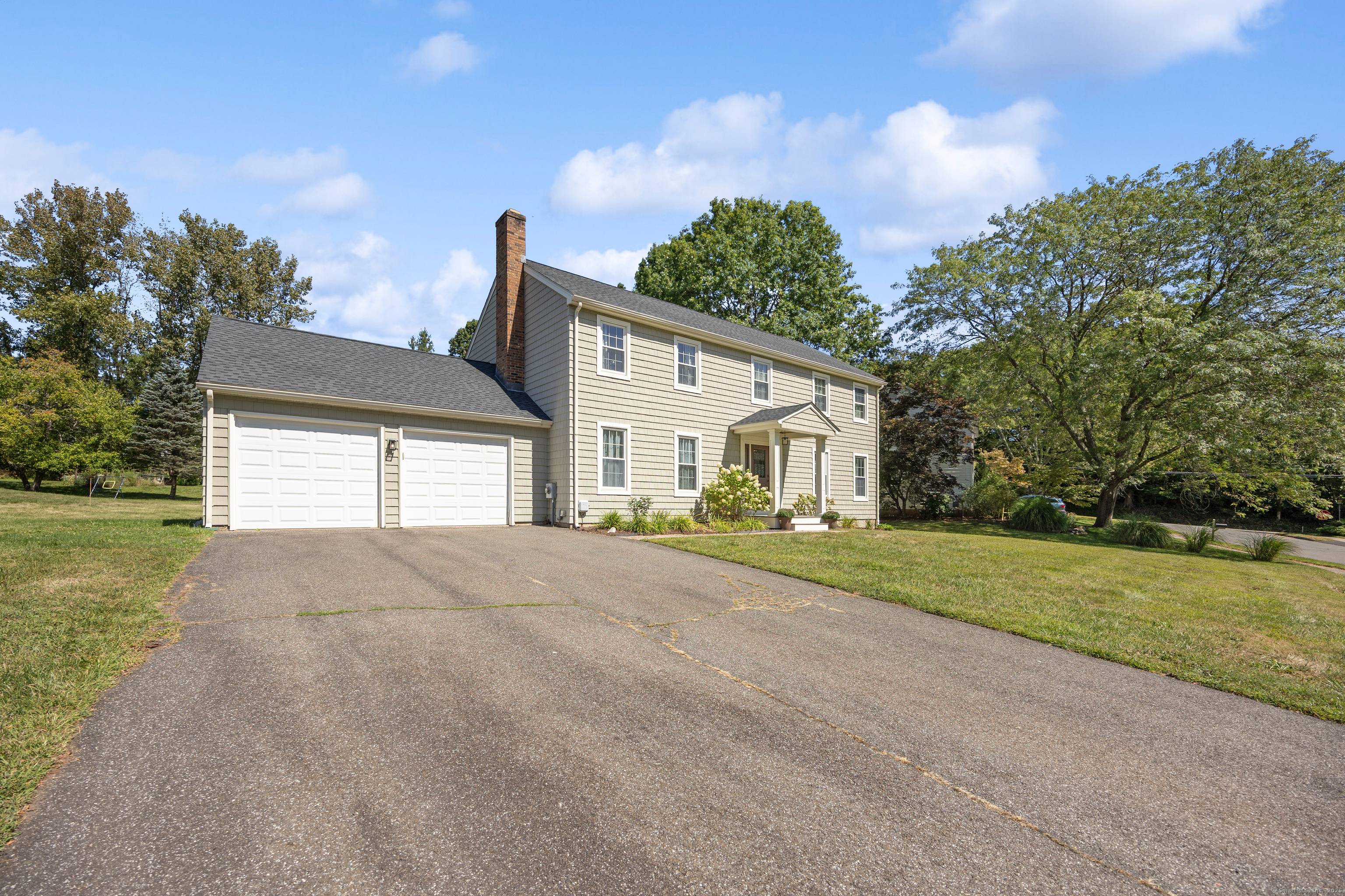 Set in a desirable and centrally located Cheshire neighborhood, this beautifully maintained and updated 4 bedroom, 2.