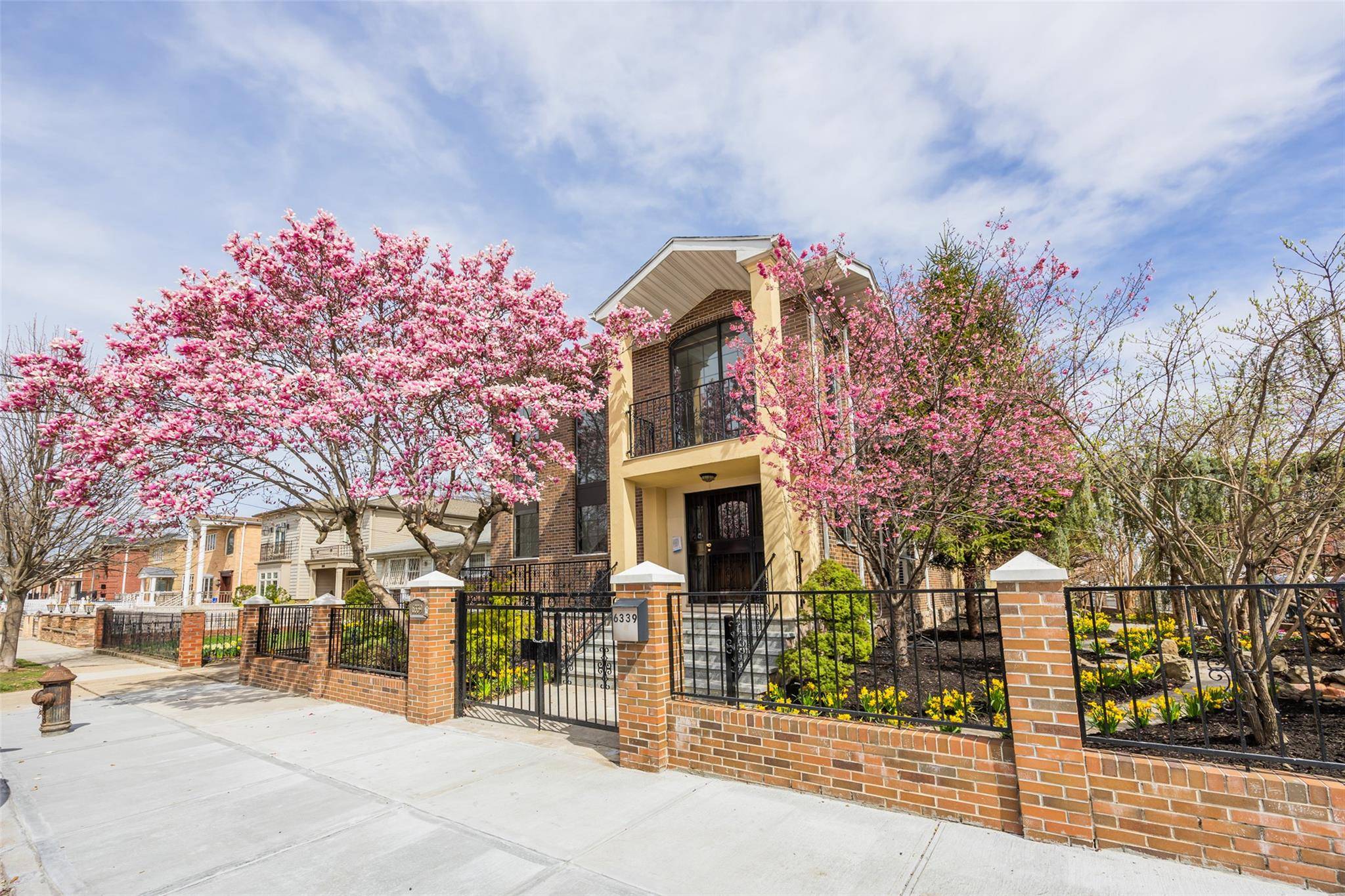 Welcome to this stunning, all brick legal two family corner home, rebuilt in 2013 and nestled in the heart of Flushing.