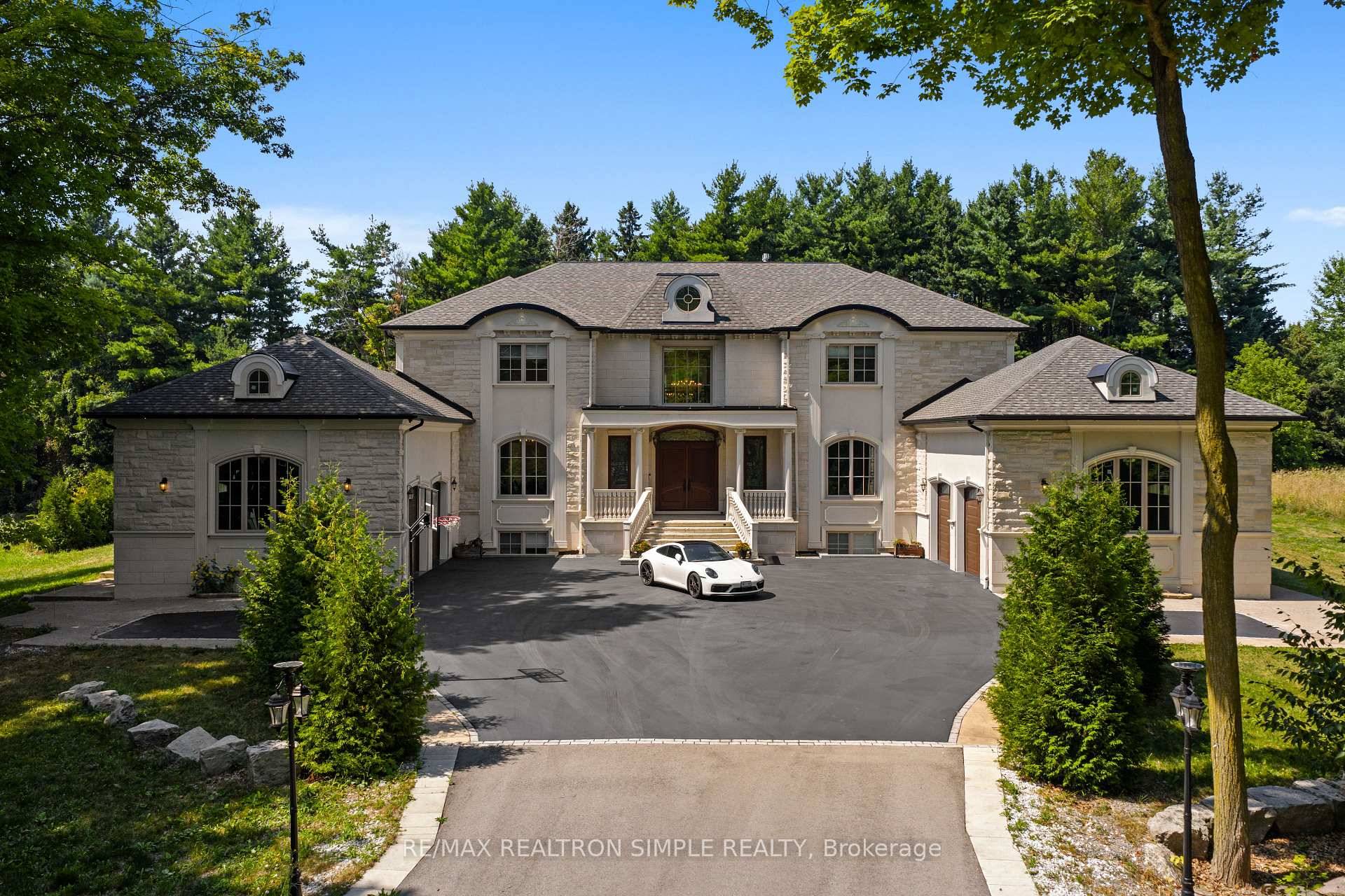 On Burlington's Bluffs, a gated stone clad estate rises with quiet confidence on nearly two acres of landscaped grounds, offering more than 12, 000 sq.