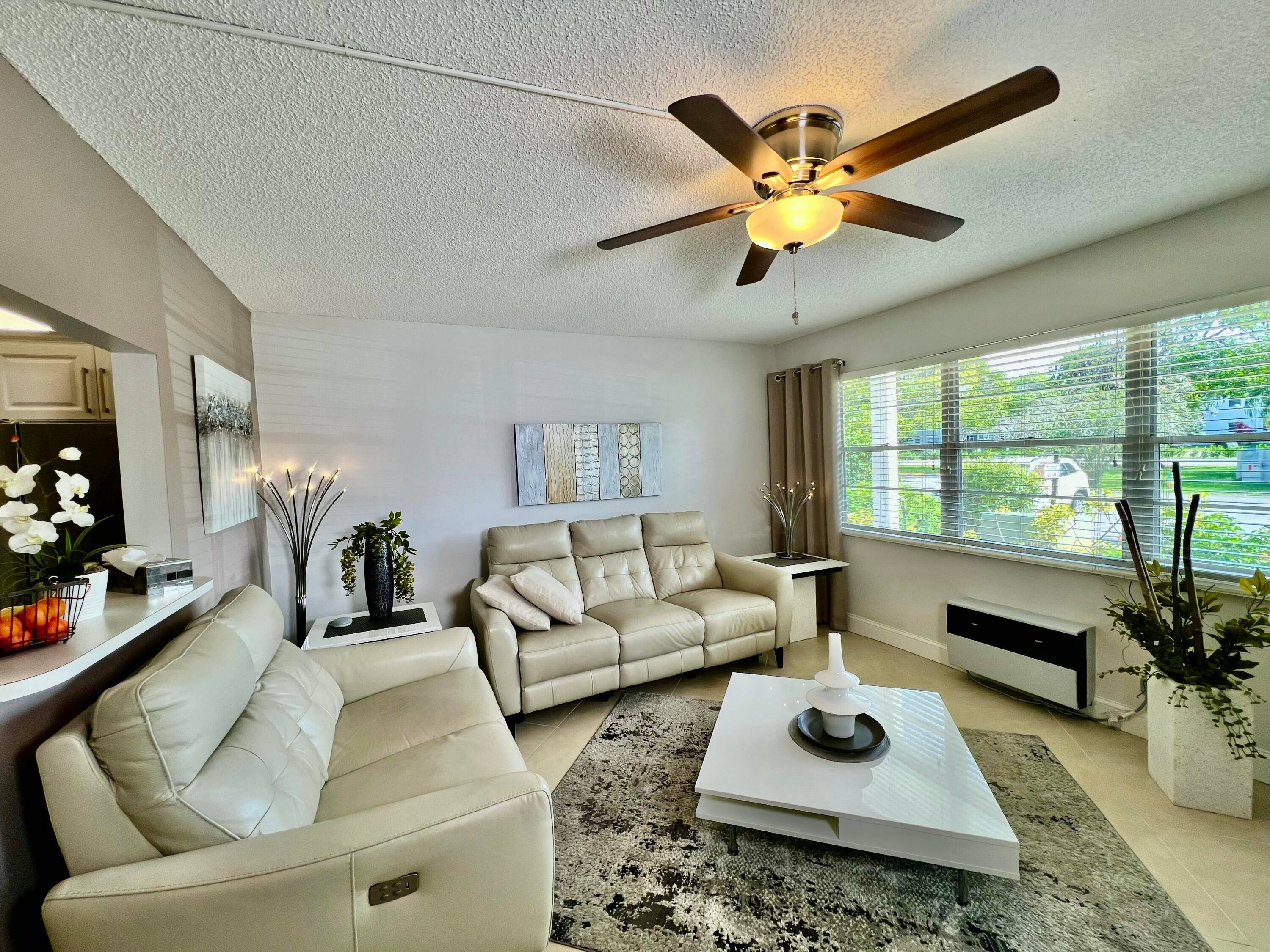 Discover modern comfort in this beautifully remodeled first floor garden condo at Century Village East.