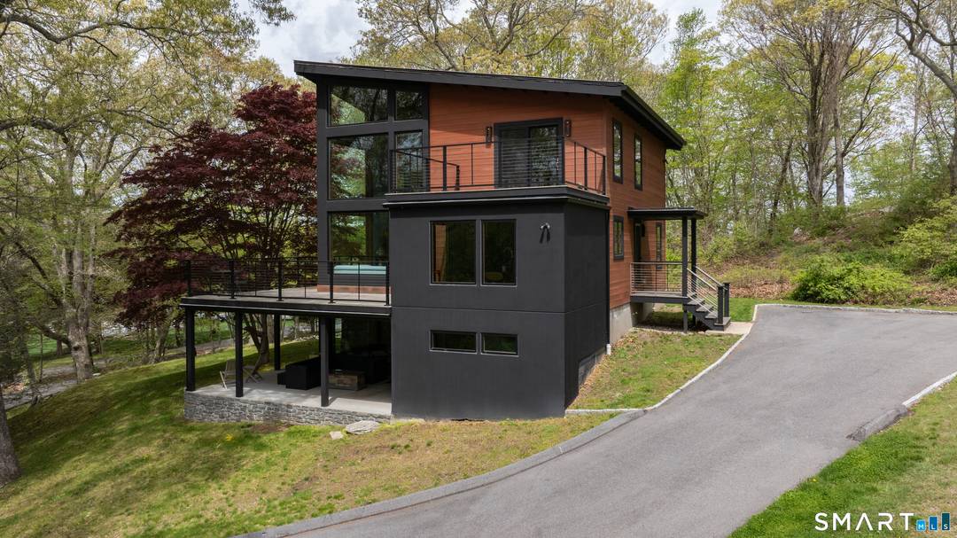 Rare, show stopping 70's contemporary on nearly 2 acres of lightly wooded landscape with dramatic stone outcroppings.
