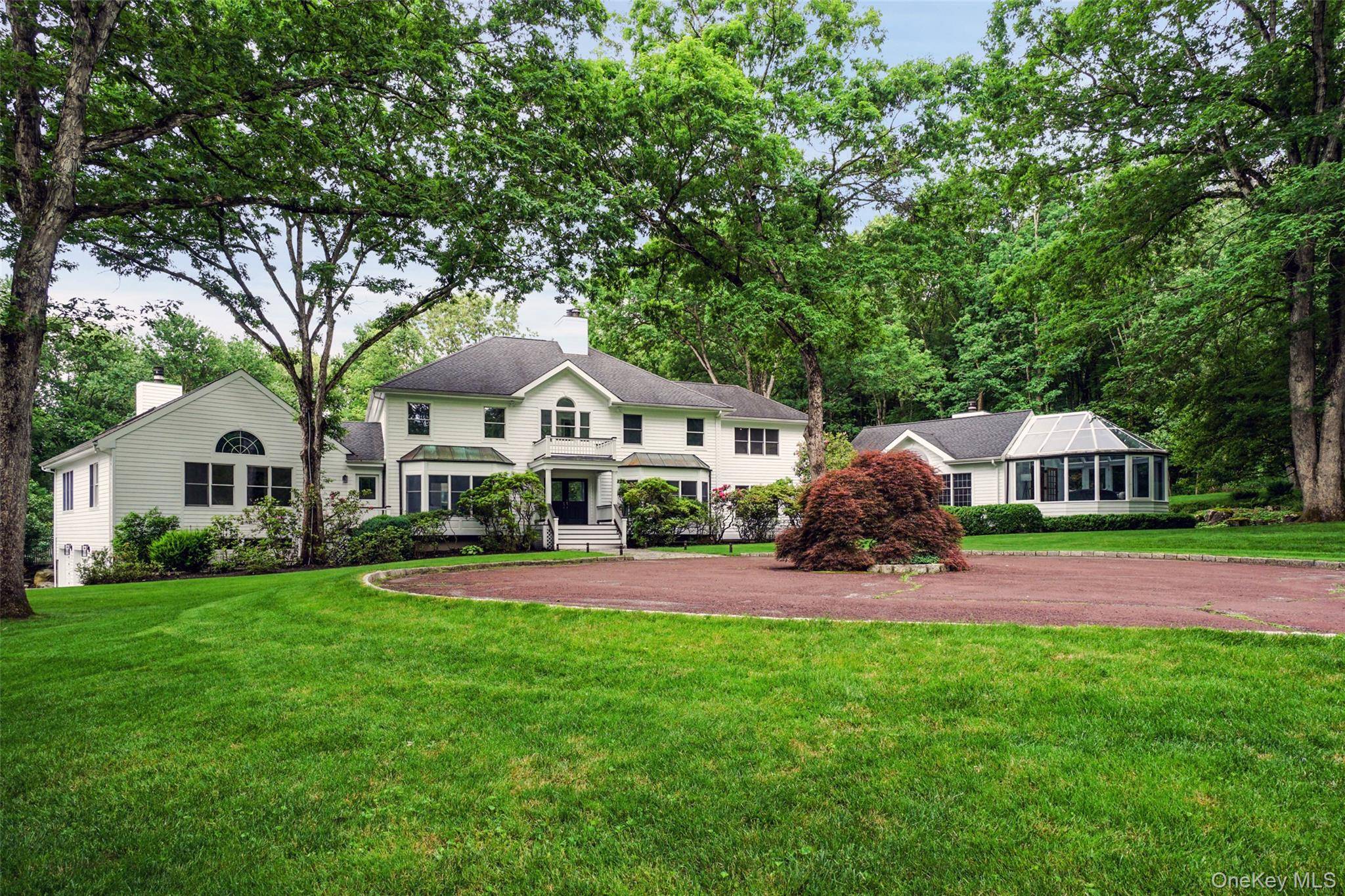 Prime Bedford gated estate on over 15 glorious acres of open, level land with spectacular age old specimen trees.