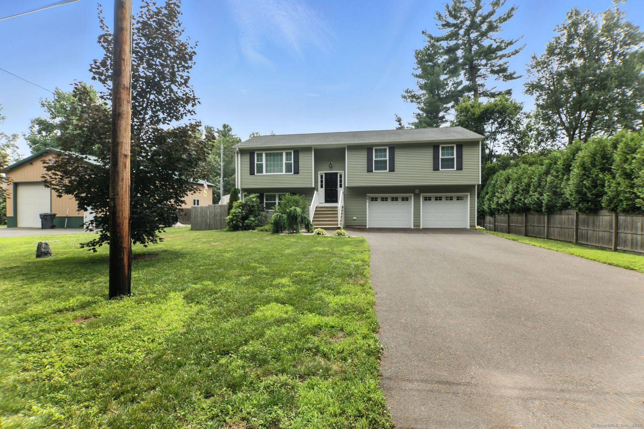 Immerse yourself in warmth and comfort in this raised ranch home's inviting interior, featuring rich wood flooring flowing through the living areas, central air conditioning for effortless relaxation, and abundant ...