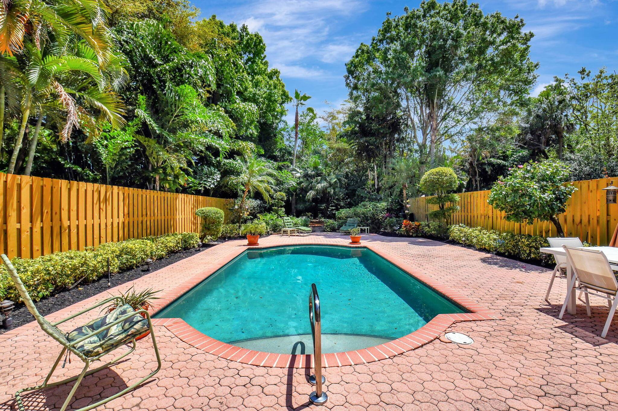 Welcome to your dream home in the sought after Village of the Banyans, nestled within the prestigious Broken Sound Country Club.