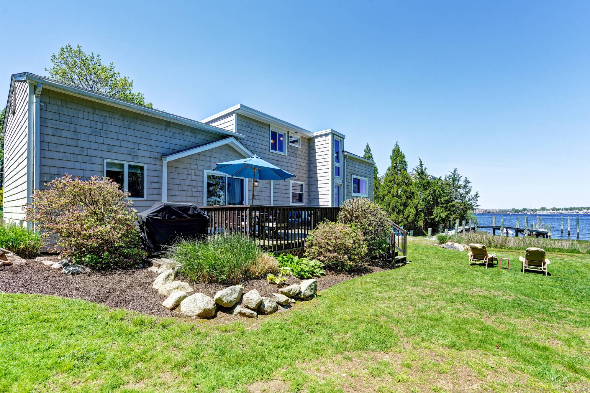 WATERFRONT ON THE MYSTIC RIVER Not a Drive BY This lovely home must be seen on the inside and from the backyard and deck in order to get the full ...