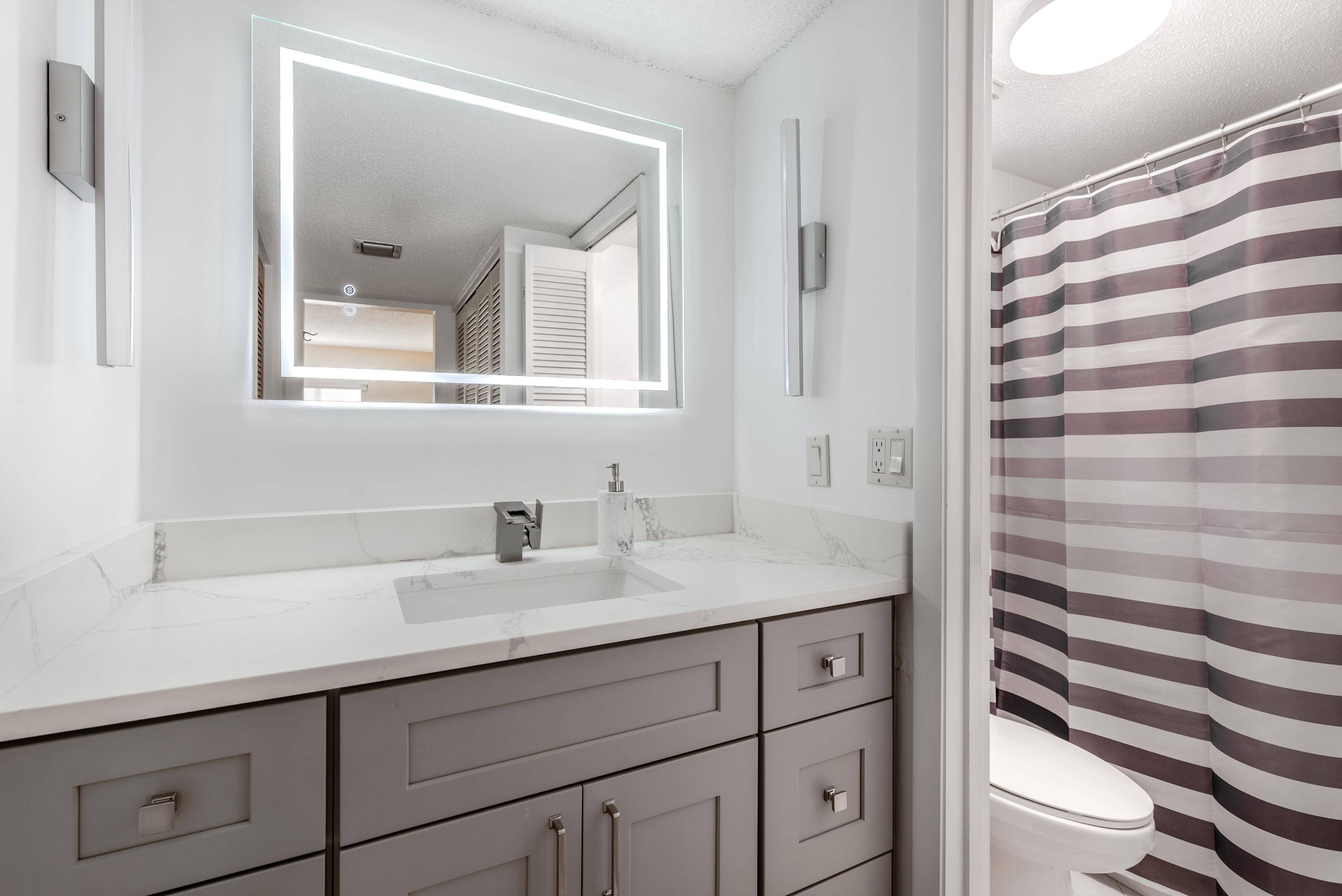 Rarely available corner unit with no neighbors on one side, offering unmatched privacy in a sought after 55 community.