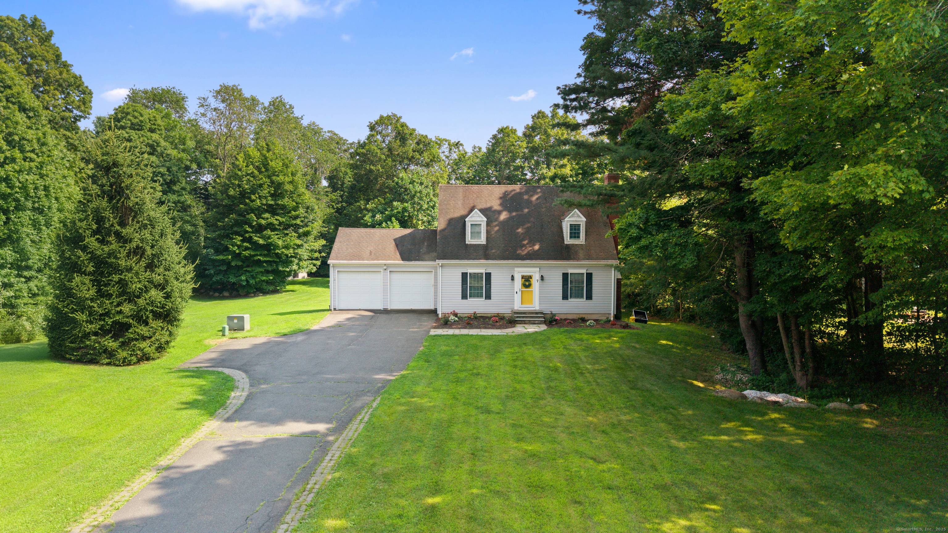 Charming and pristine Cape style home featuring elegant wainscoting and hardwood floors throughout.