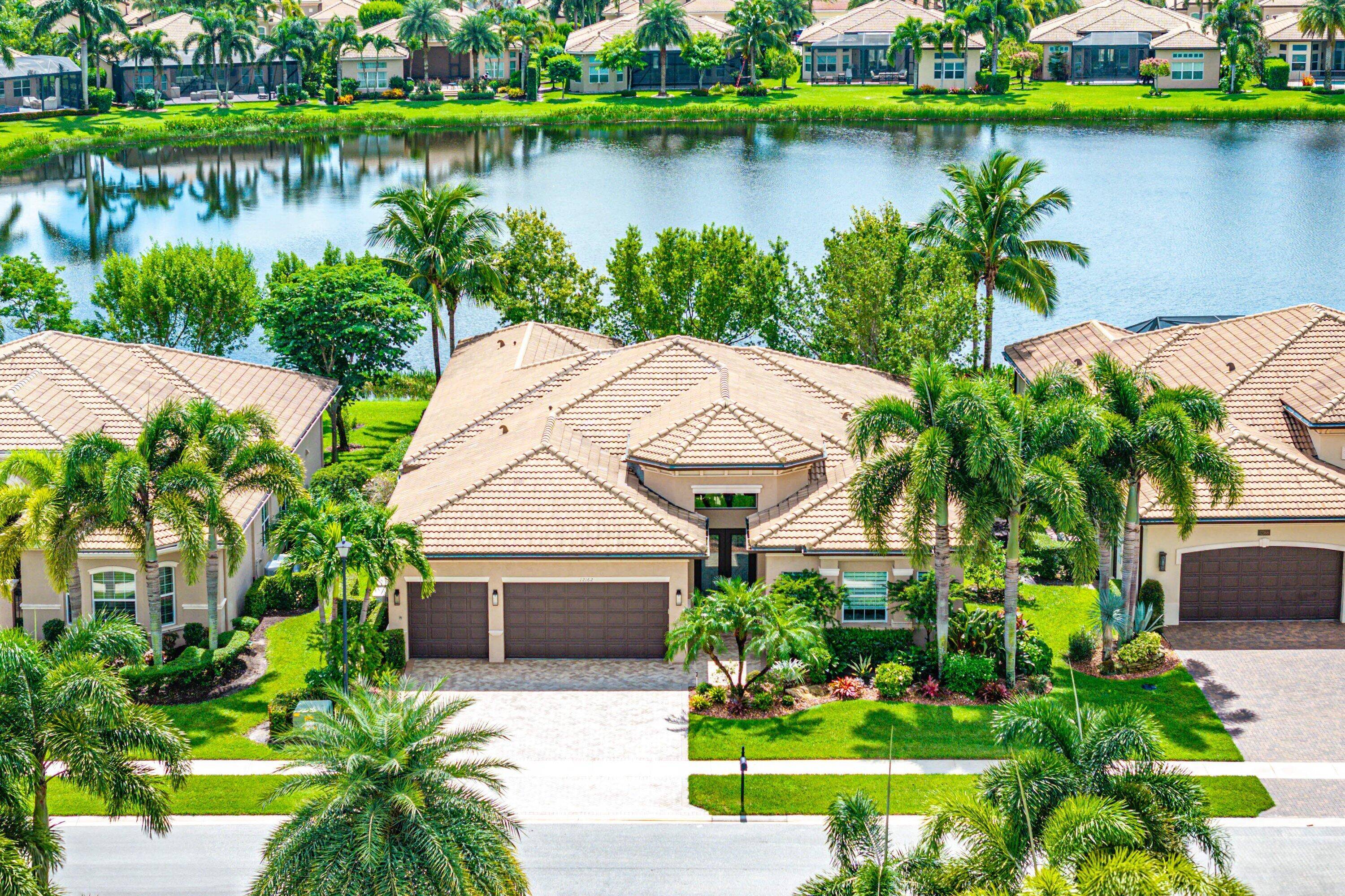 Elegant Charleston Grande on a south facing lakefront lot with a spacious screened patio.