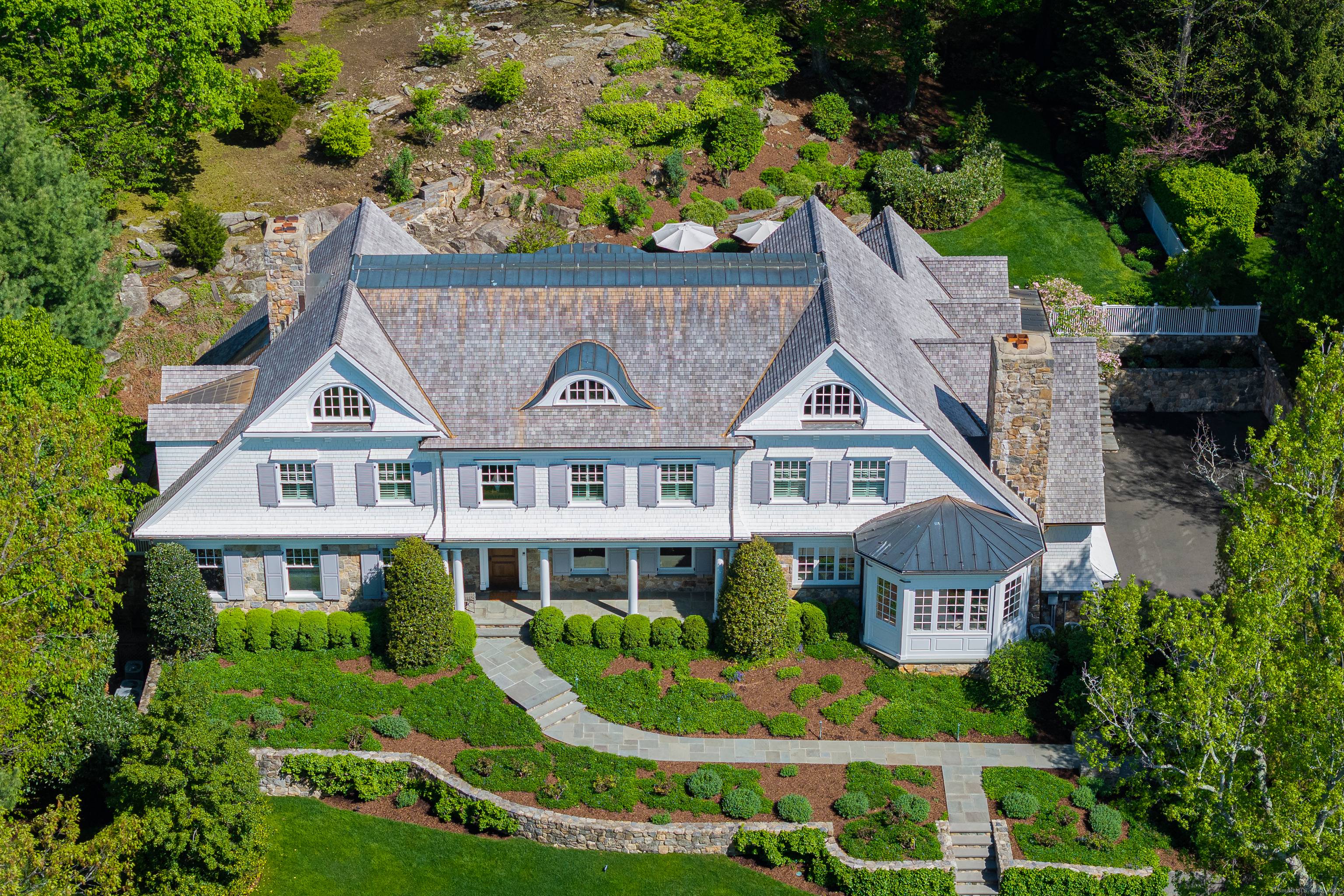 With timeless appeal, this quintessential New England stone shingle style colonial offers finely crafted architectural details with thoughtful design and exceptional quality.