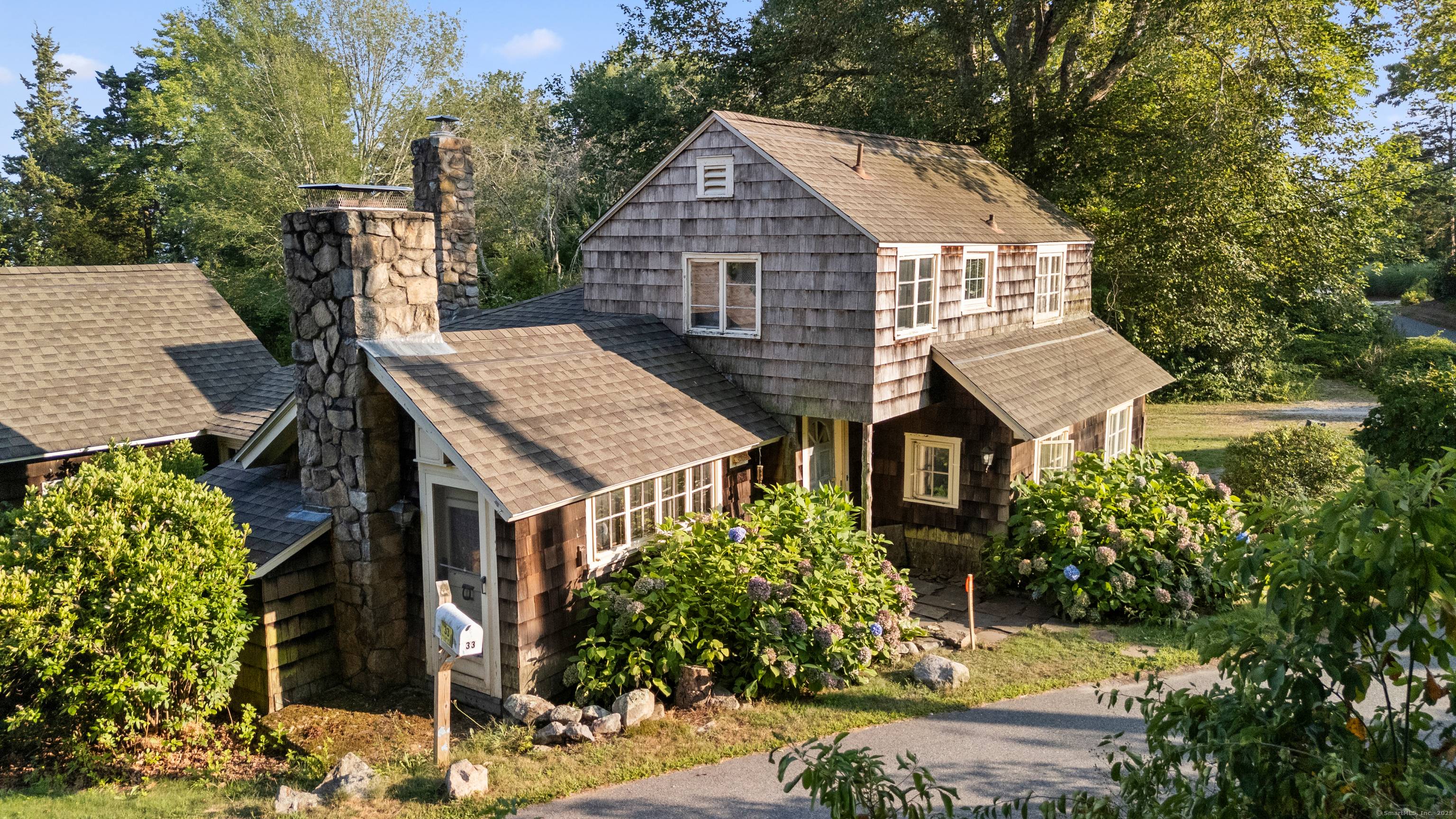 Direct Water Front with Unobstructed Water Views from this Charming Cozy Circa 1932 Two Story English Style Cottage.