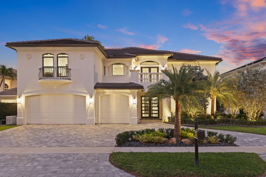 Fully renovated Mizner Country Club estate with sweeping golf and lake views.