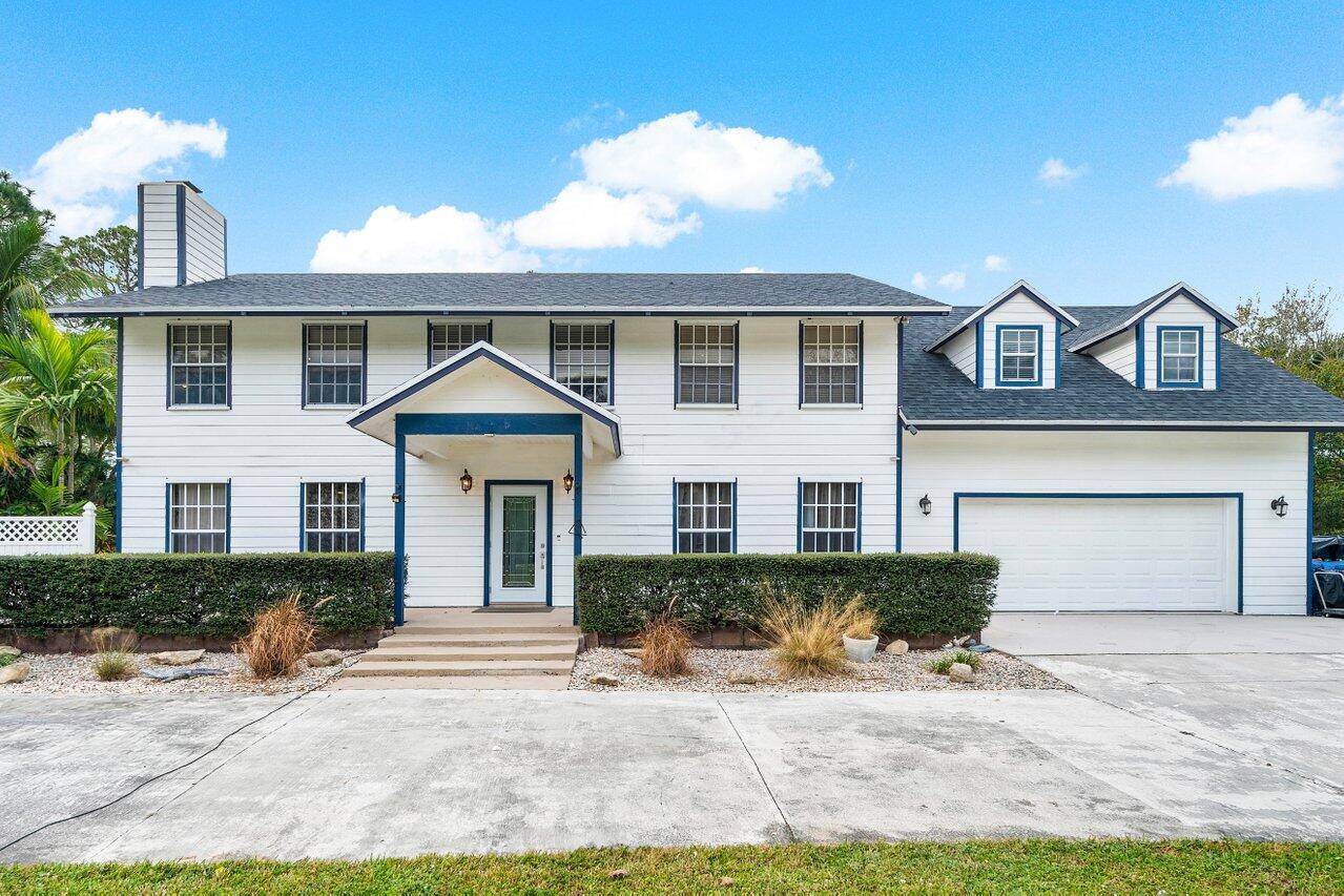 Embrace the Jupiter Farms lifestyle with this 4 bedroom, 2.