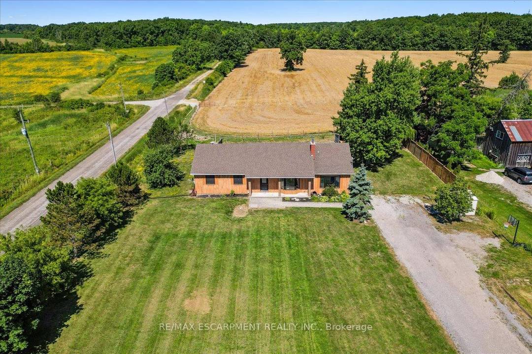 Set on just over an acre and backing onto peaceful farmland, this beautifully updated 4 1 bedroom, 4 bath bungalow delivers the perfect balance of space, privacy, and modern comfort.