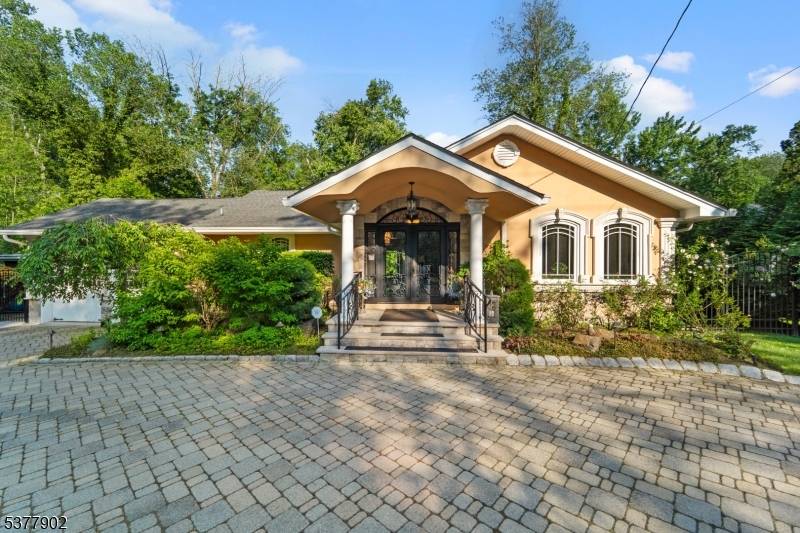 Nestled on nearly half an acre of beautifully landscaped grounds, this meticulously renovated steel beam constructed ranch offers a seamless blend of quality craftsmanship and thoughtful design.