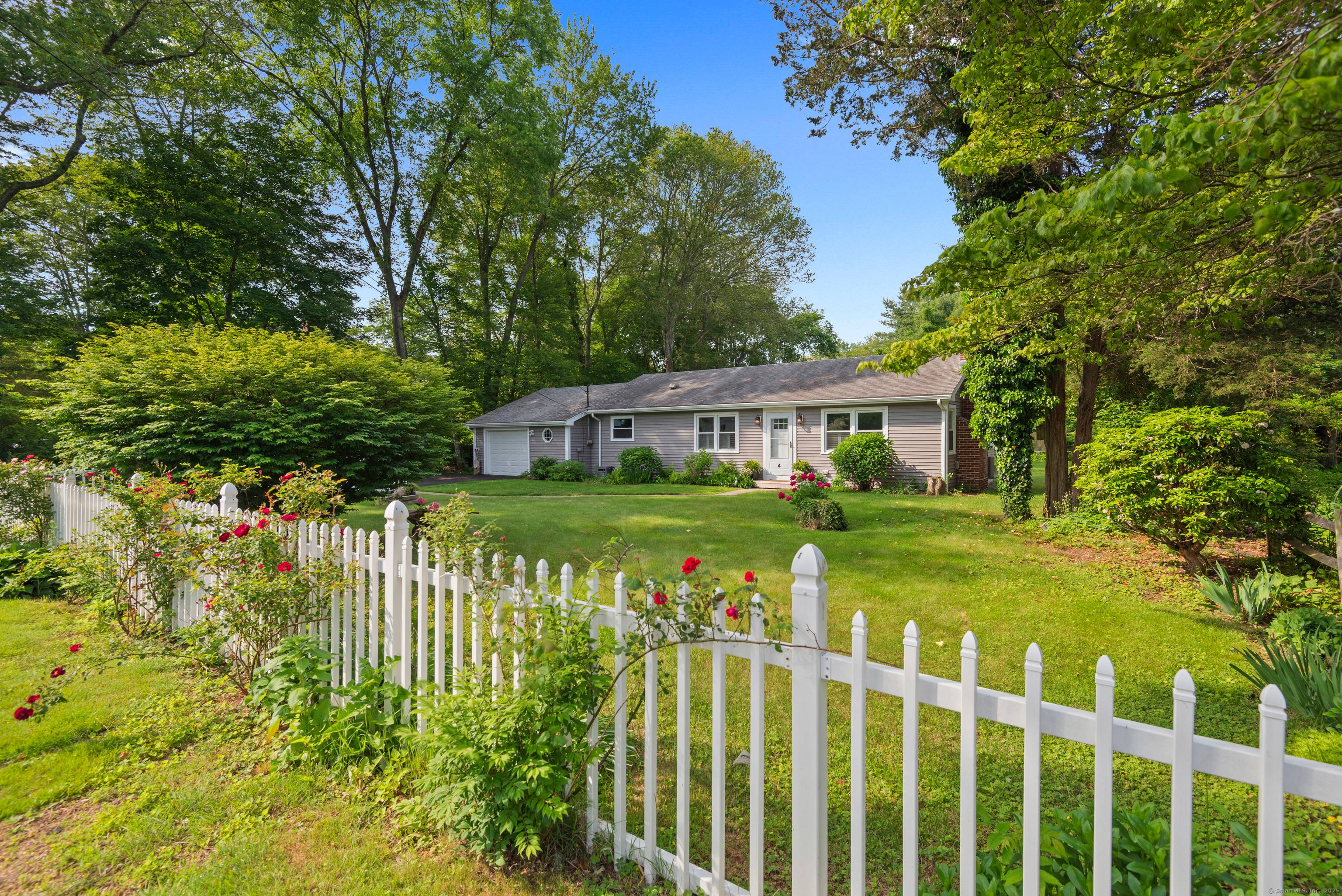 One mile north of Old Lyme village, this beautifully renovated, turn key, ranch style home is framed by a manicured, level half acre.