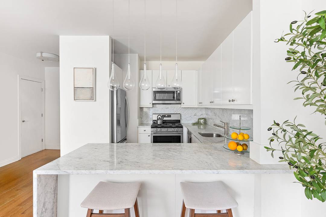 This thoughtfully renovated two bedroom, two bathroom condo is the one you've been waiting for set within a beautifully converted industrial building in the heart of Park Slope.