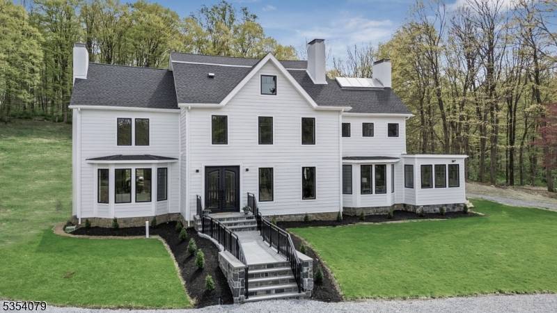 Striking 2023 2024 renovated Custom Colonial set atop 8 scenic acres in one of Morris Township's most prestigious and private locations.