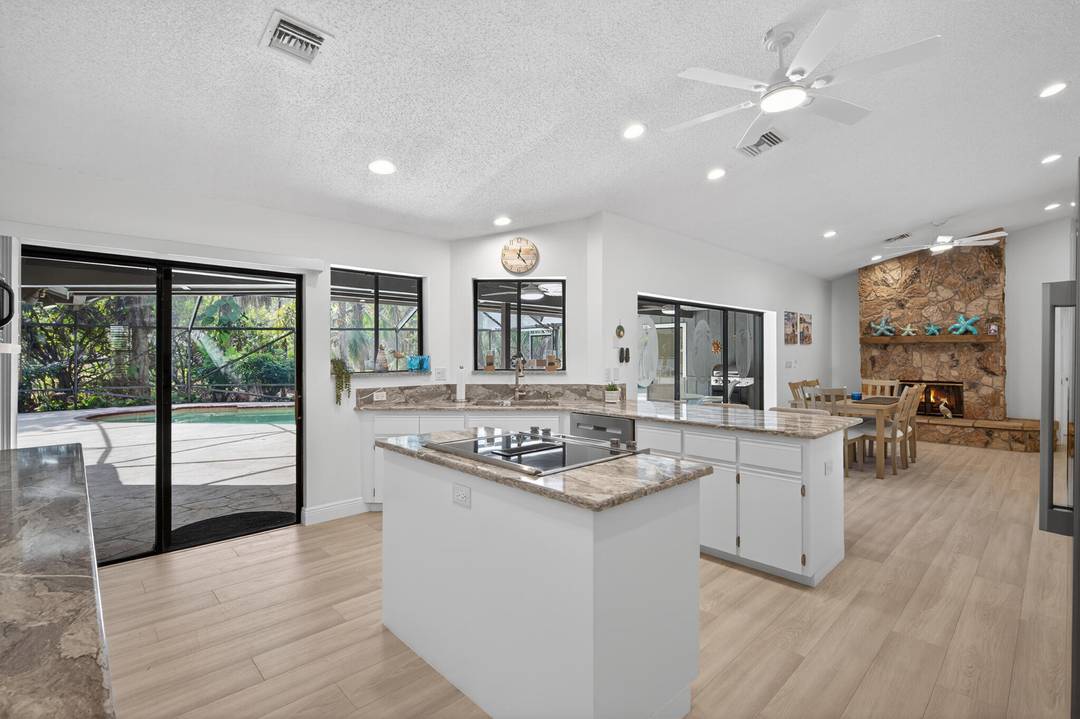 Escape to this secluded Palm Beach Gardens retreat set on over an acre of lush tropical landscaping.