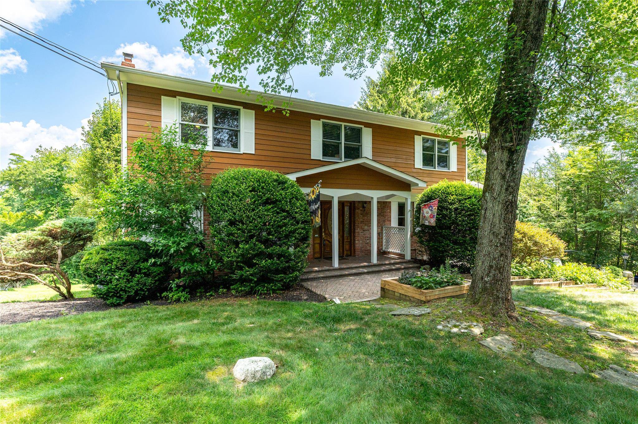 A distinguished Colonial nestled on nearly two level scenic acres, where a peaceful garden sanctuary awaits.