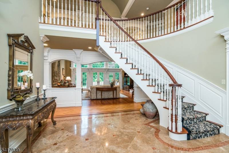 Stately, custom Leonard built, all brick, steel beam construction Colonial gracefully set on a spectacular, private cul de sac.