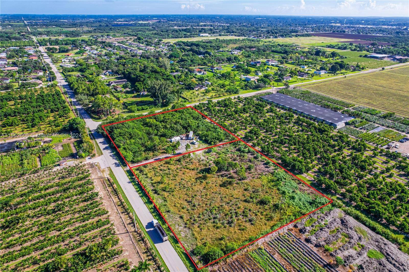 Embrace the tranquil charm of rural living on this expansive 4.