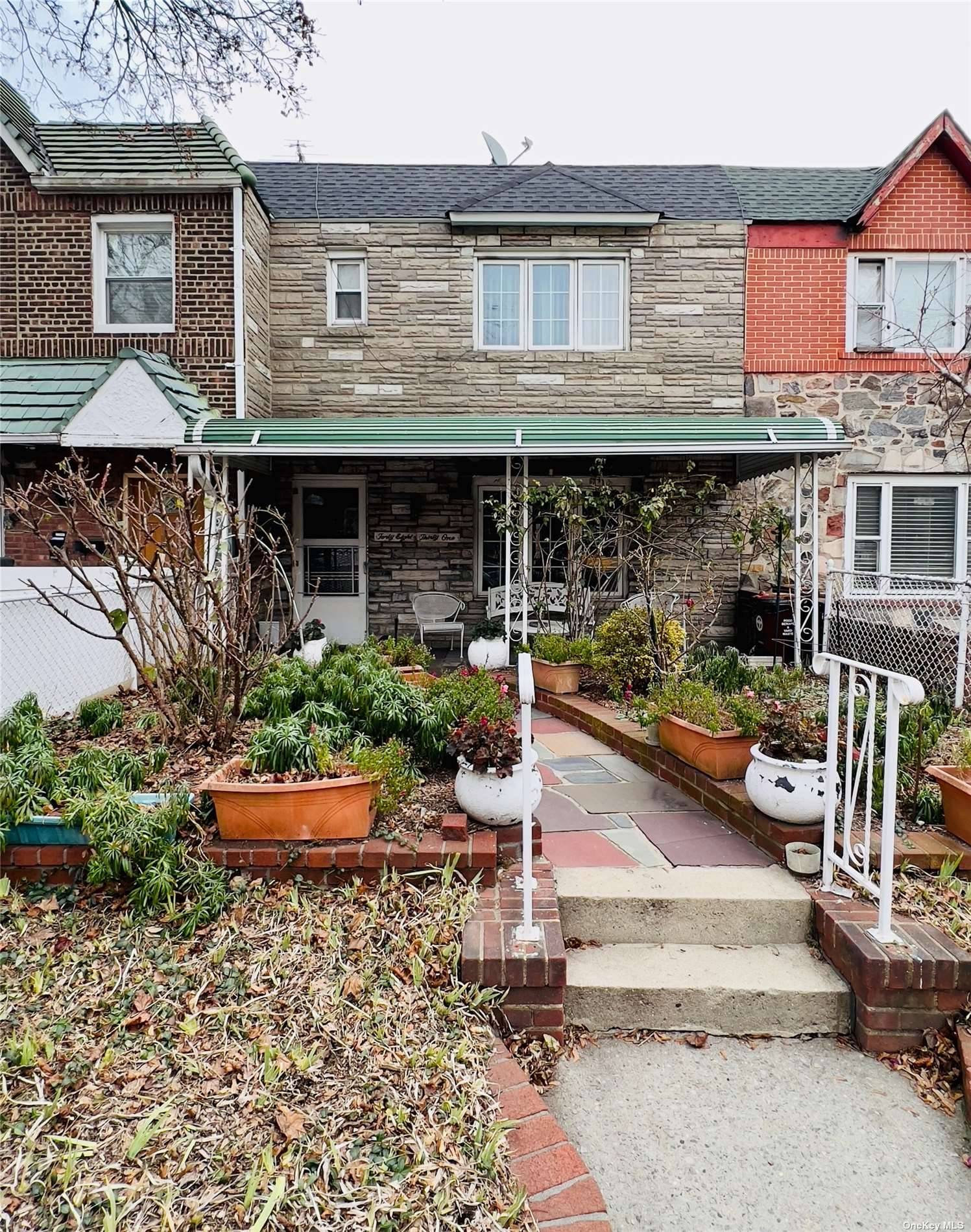 Solid brick attached 2 family in a very convenient Woodside location.