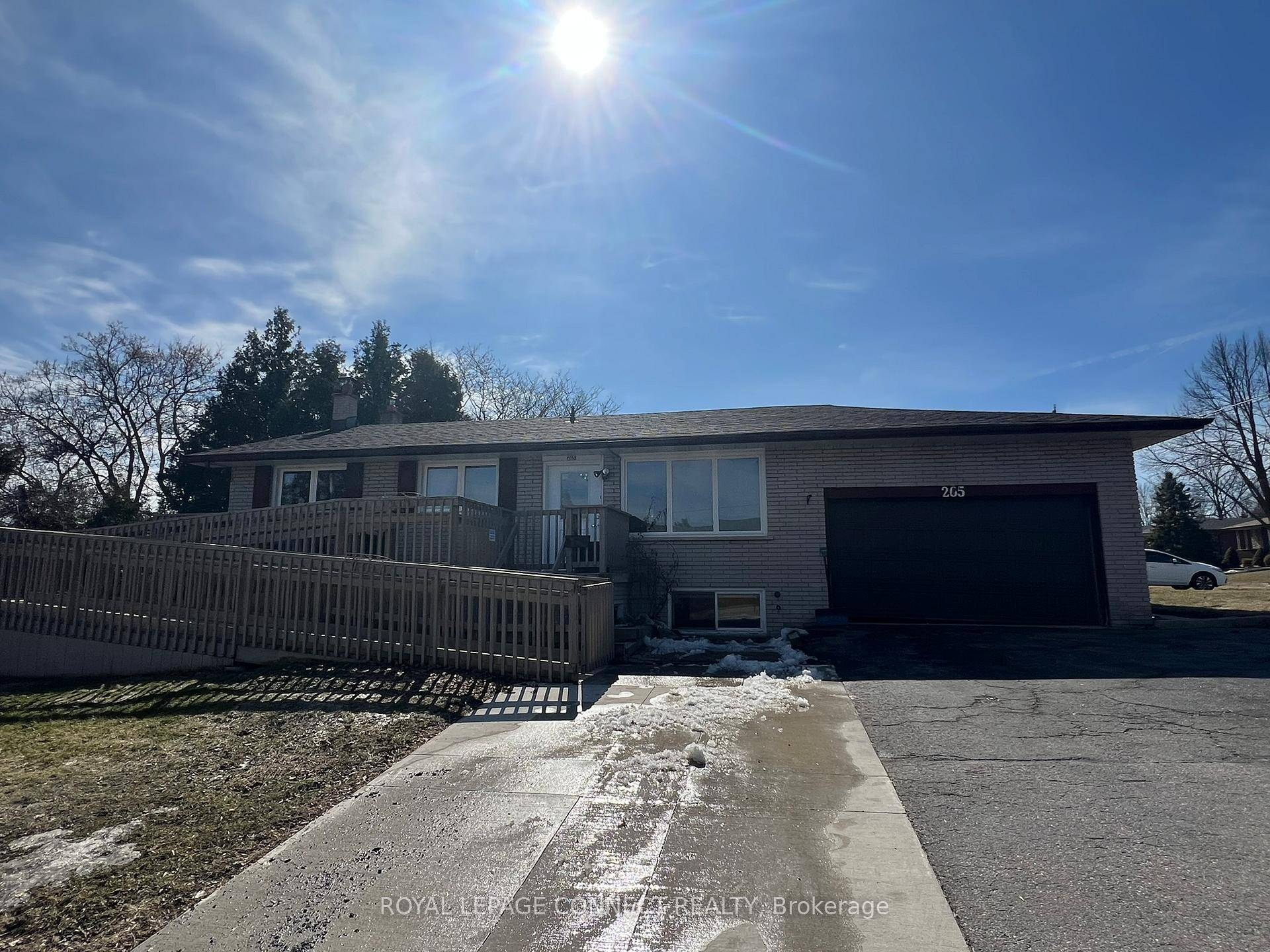 Accessible brick bungalow with wheelchair ramp, wheelchair ceiling lifts in the living room, lifts in 2 of the bedrooms, and a bathroom with lift and roll in shower.
